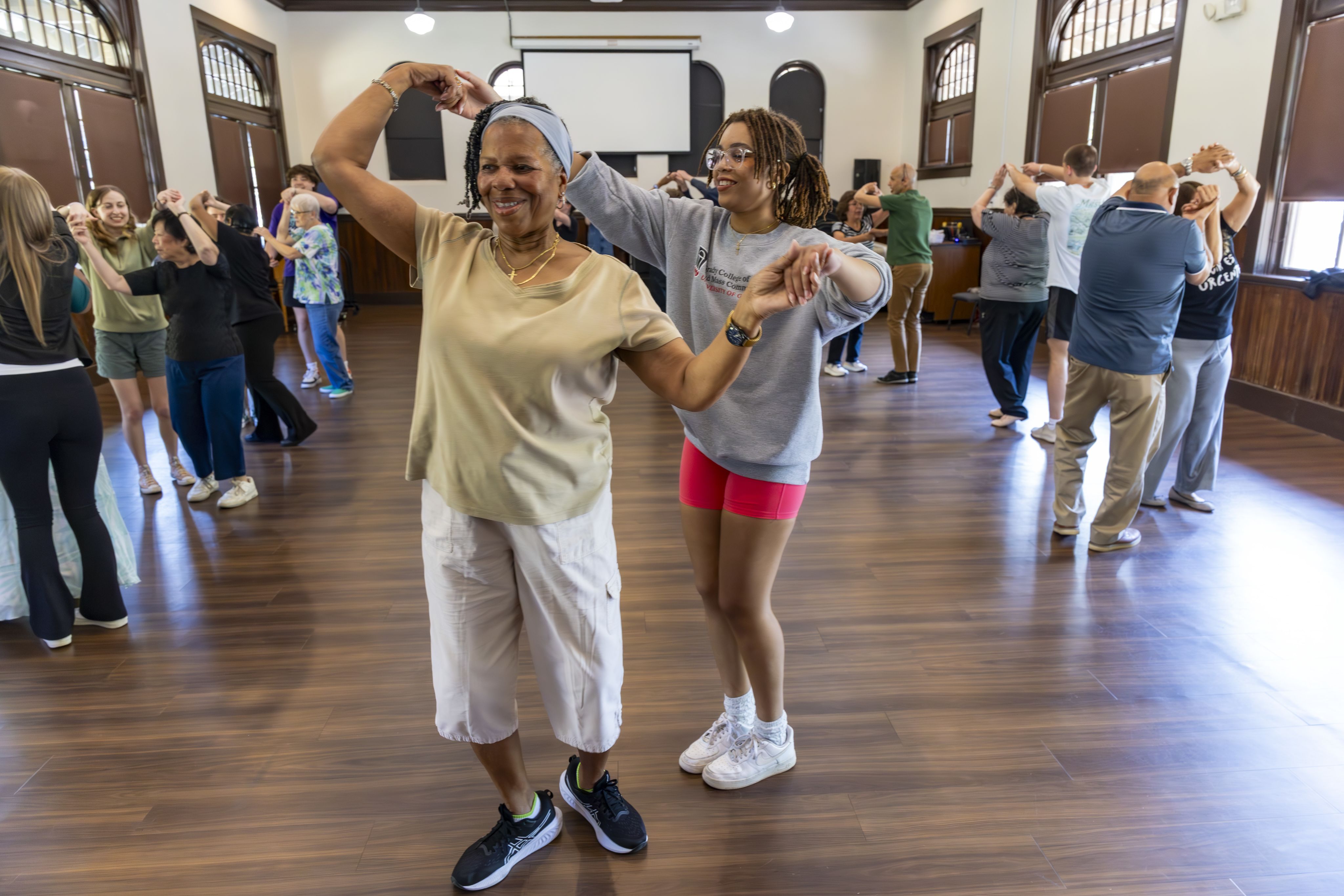 UGA students dance with senior members of the community during a service-learning class
