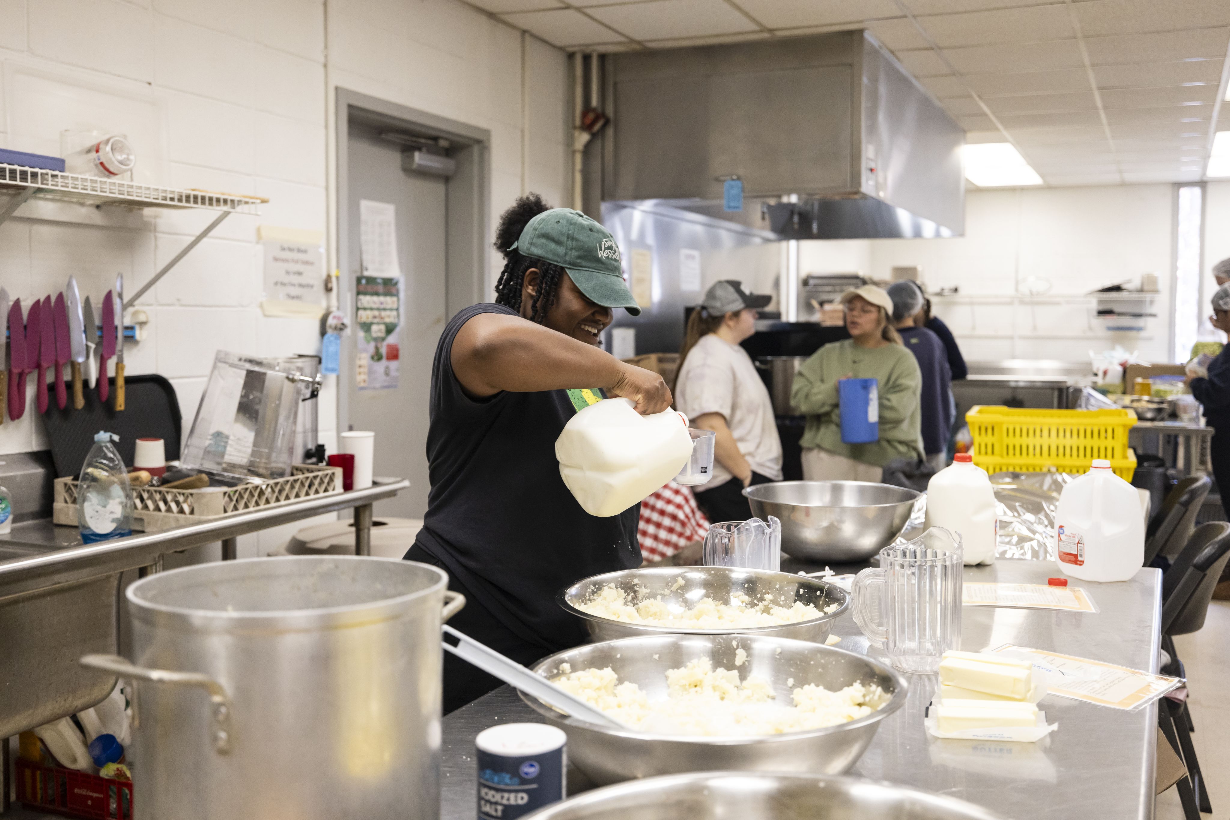 Campus Kitchen grad student Tomaiya Stafford measures ingredients in the kitchen.
