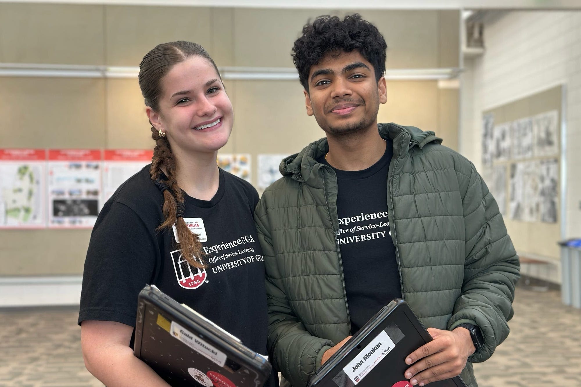 Experience UGA Ambassadors Gabi Witucki and John Mookken smile while leading a trip