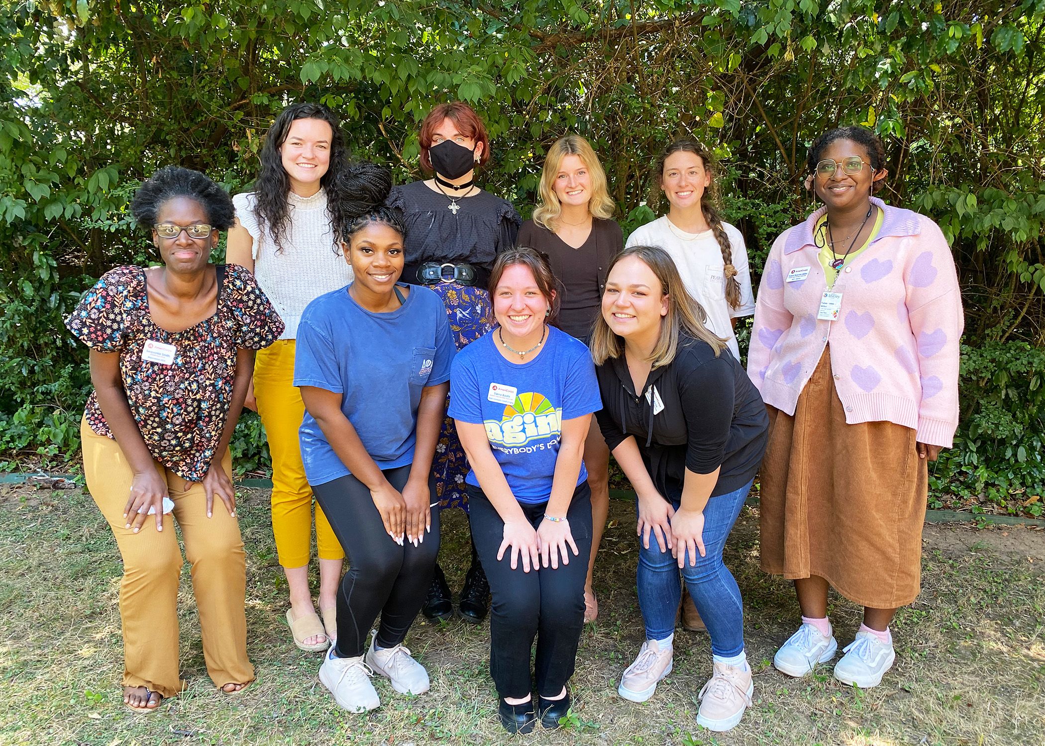 AmeriCorps VISTAs pose for a photo outside the Office of Service-Learning.