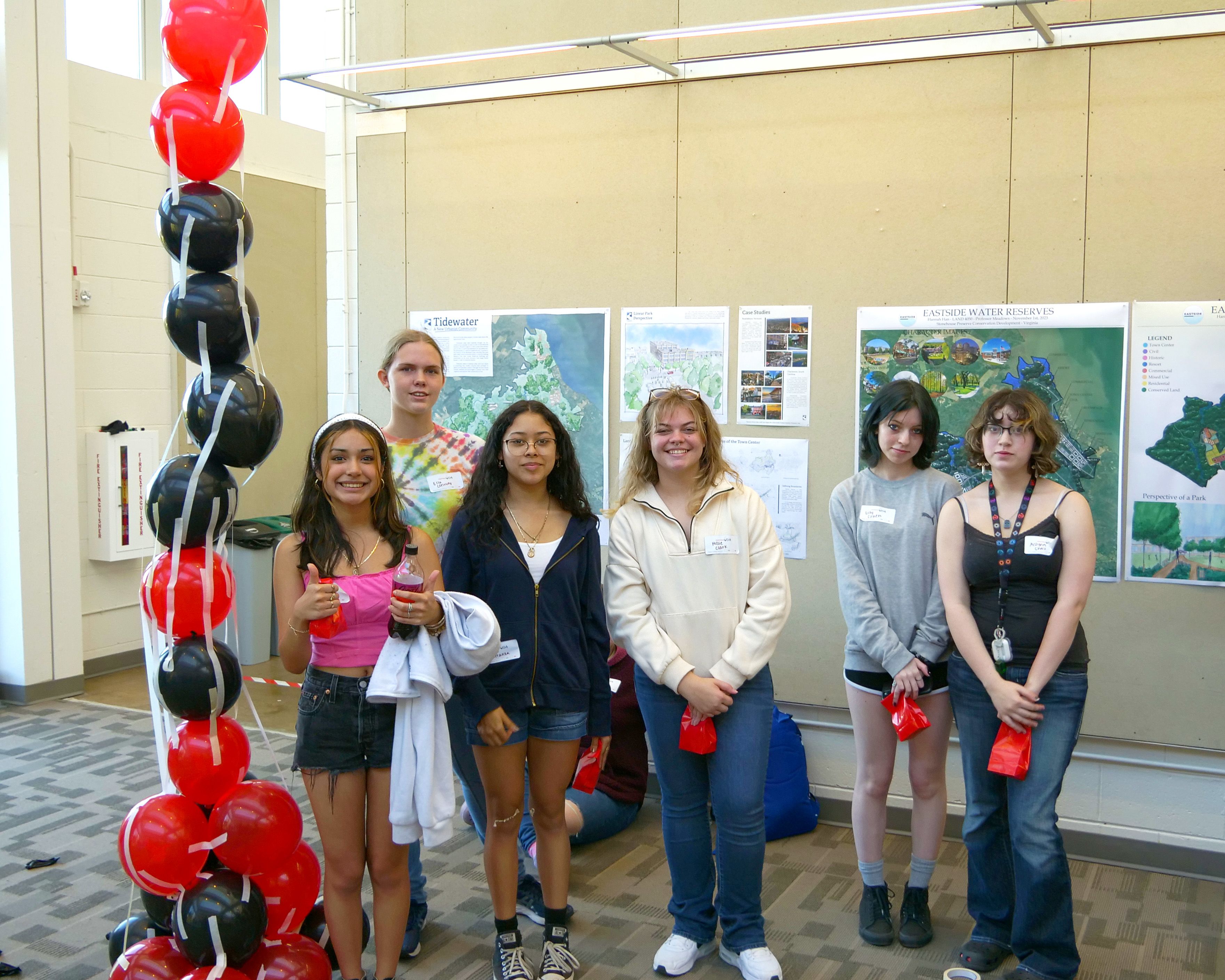 10th grade students pose next to the balloon tower they constructed on an Experience UGA trip.