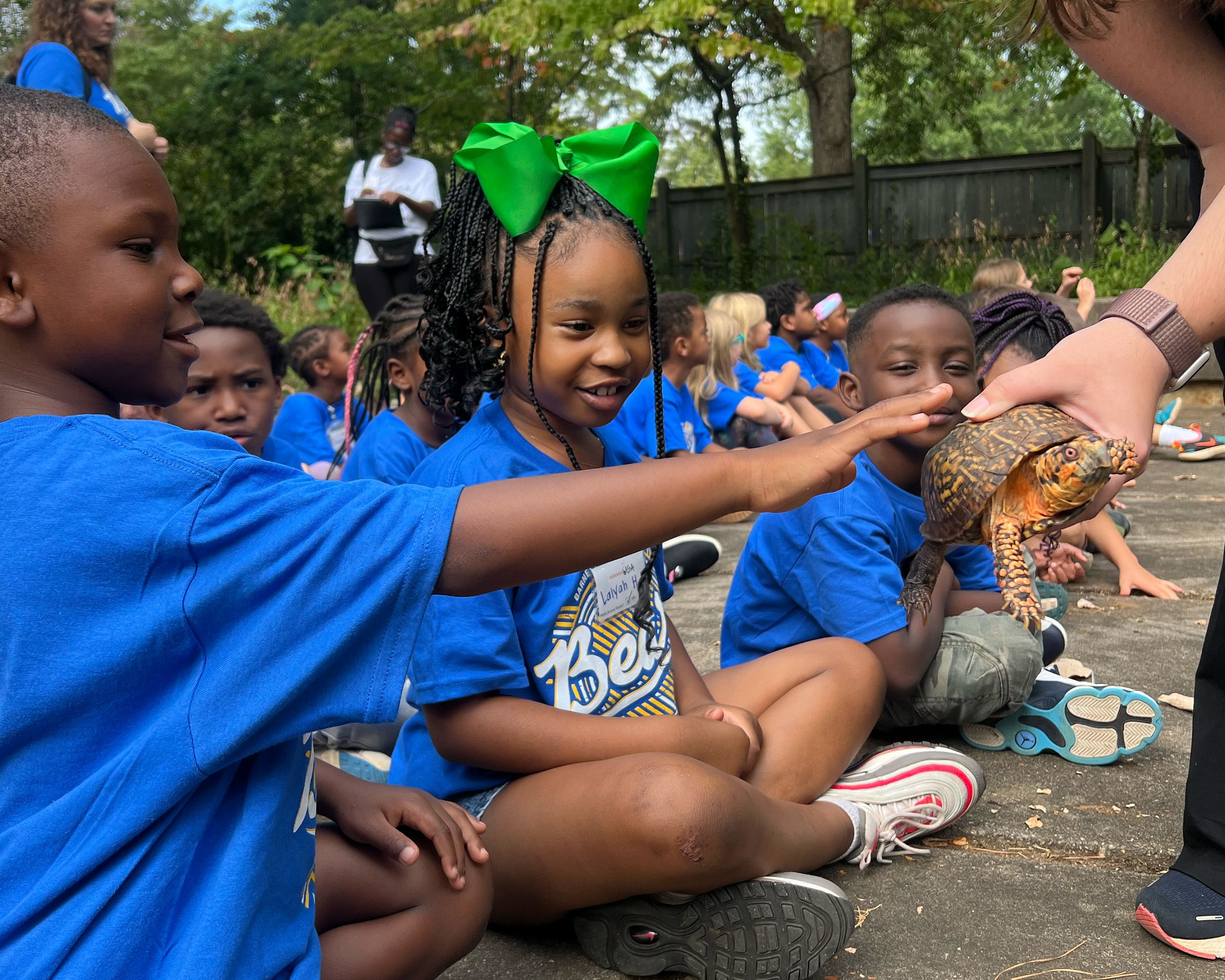 Elementary school kids get a close view of a turtle on an Experience UGA trip.