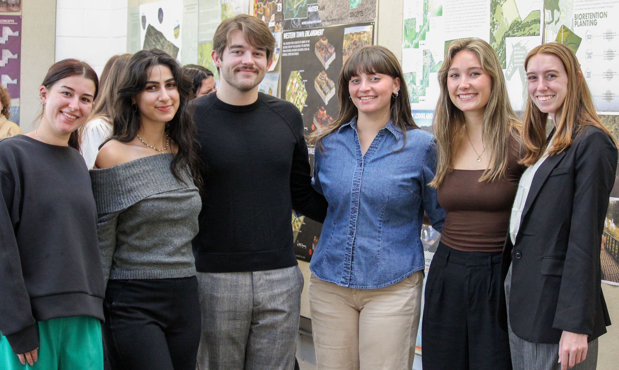Six students pose for a photo on their final critique day